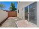 Private backyard featuring gravel, pavers, stone steps, and sliding glass door entrance at 7249 Linaria Rd, Las Vegas, NV 89113