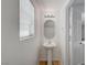 Powder room featuring pedestal sink, a window, and modern lighting at 7249 Linaria Rd, Las Vegas, NV 89113