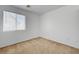 Bright bedroom featuring neutral carpet, window and base trim with a large window providing ample natural light at 7249 Linaria Rd, Las Vegas, NV 89113