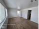 Spacious bedroom with neutral carpeting, white walls, and natural light from the window at 7249 Linaria Rd, Las Vegas, NV 89113