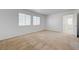 Well-lit bedroom featuring neutral carpet and two windows at 7249 Linaria Rd, Las Vegas, NV 89113