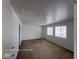 Large bedroom with neutral carpeting, white walls and ceiling, with natural light from two windows at 7249 Linaria Rd, Las Vegas, NV 89113