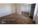Bedroom featuring neutral carpet, white walls and mirrored closet with a view into the walk-in closet at 7249 Linaria Rd, Las Vegas, NV 89113