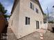 View of the home's exterior featuring a sliding glass door and low-maintenance backyard at 7249 Linaria Rd, Las Vegas, NV 89113