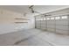 Spacious two-car garage with an automatic door opener and shelving for storage at 7249 Linaria Rd, Las Vegas, NV 89113