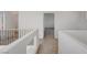 Second floor hallway with carpet flooring and decorative railing at 7249 Linaria Rd, Las Vegas, NV 89113