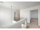Upstairs hallway with carpet flooring and a decorative wrought iron railing at 7249 Linaria Rd, Las Vegas, NV 89113