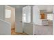 Open-concept hallway with column accents leading to a bright kitchen and bathroom at 7249 Linaria Rd, Las Vegas, NV 89113