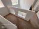 Hallway overlooking foyer featuring neutral carpeting, white walls and staircase at 7249 Linaria Rd, Las Vegas, NV 89113