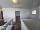 Hallway showing neutral walls, carpet and banister leading to a bedroom with natural light at 7249 Linaria Rd, Las Vegas, NV 89113