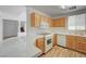 Well-lit kitchen with warm wood cabinets, white countertops, and modern appliances with natural light at 7249 Linaria Rd, Las Vegas, NV 89113