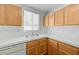 Well-lit kitchen with wooden cabinets, a double sink, and white tile countertops at 7249 Linaria Rd, Las Vegas, NV 89113