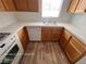 Bright kitchen featuring white appliances, laminate flooring, and tile countertops at 7249 Linaria Rd, Las Vegas, NV 89113