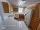 Fully-equipped kitchen boasting tile counters, wooden cabinets and modern appliances at 7249 Linaria Rd, Las Vegas, NV 89113