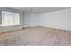 Bright living room with neutral walls, plush carpeting and a window offering natural light at 7249 Linaria Rd, Las Vegas, NV 89113