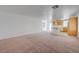 Spacious living room with neutral color palette connecting to a kitchen area with warm wood cabinets at 7249 Linaria Rd, Las Vegas, NV 89113