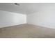 Large, empty living room with neutral walls and carpeting, ready for personalized decor at 7249 Linaria Rd, Las Vegas, NV 89113