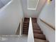 Stairway leads to upper level, featuring a skylight and carpeted steps at 7249 Linaria Rd, Las Vegas, NV 89113