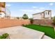 Private backyard featuring a patio, small patch of artificial turf, and secure brick perimeter wall at 7566 Glowing Ember Ct # 101, Las Vegas, NV 89130