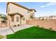 Backyard with a synthetic lawn, block wall, and spiral stairs at 7566 Glowing Ember Ct # 101, Las Vegas, NV 89130