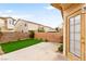 Private outdoor patio and artificial turf with exterior access door to upper level and spiral staircase at 7566 Glowing Ember Ct # 101, Las Vegas, NV 89130