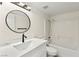 Clean bathroom with a shower-tub combo and a modern round mirror at 7566 Glowing Ember Ct # 101, Las Vegas, NV 89130