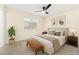 Well-lit bedroom with a ceiling fan, cozy bed, and stylish furnishings at 7566 Glowing Ember Ct # 101, Las Vegas, NV 89130