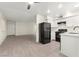 Open-concept kitchen and living room area with new appliances and wood flooring at 7566 Glowing Ember Ct # 101, Las Vegas, NV 89130
