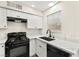 Modern kitchen featuring white cabinets, quartz countertops, and black appliances at 7566 Glowing Ember Ct # 101, Las Vegas, NV 89130