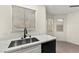 Kitchen area featuring quartz countertops, stainless steel sink, and bright window at 7566 Glowing Ember Ct # 101, Las Vegas, NV 89130