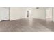 Open living room featuring light wood flooring and a bright white front door at 7566 Glowing Ember Ct # 101, Las Vegas, NV 89130