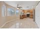 Bright kitchen includes tile floors, wood cabinets, stainless steel appliances, and an adjacent dining area at 7711 Lofty Hill Ct, Las Vegas, NV 89123