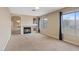 Spacious living room featuring a fireplace and neutral carpet at 7711 Lofty Hill Ct, Las Vegas, NV 89123
