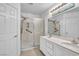 Bright bathroom featuring double sinks with a marble countertop and a walk-in shower with safety bars at 7886 Palace Monaco Ave, Las Vegas, NV 89117