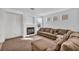 Comfortable living room with a cozy fireplace and plush sectional sofa and carpeted floors at 7886 Palace Monaco Ave, Las Vegas, NV 89117