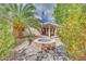 Backyard with fire pit and tropical landscaping, perfect for outdoor entertainment at 7908 Morning Gallop Ct, Las Vegas, NV 89131