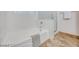 Modern bathroom with large tub, towel and sliding glass door, with neutral decor and tile flooring at 7908 Morning Gallop Ct, Las Vegas, NV 89131