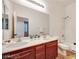 This full bath features a double sink vanity, large mirror and a shower-tub combination at 7908 Morning Gallop Ct, Las Vegas, NV 89131