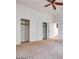 This bedroom features carpet, a ceiling fan, and a closet for ample storage at 7908 Morning Gallop Ct, Las Vegas, NV 89131