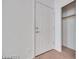 Neutral bedroom showcasing a white closet door and a standard door leading to another room at 7908 Morning Gallop Ct, Las Vegas, NV 89131