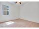 Carpeted bedroom with neutral walls and a window that brings in natural light at 7908 Morning Gallop Ct, Las Vegas, NV 89131