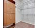 Walk-in closet with custom wood cabinets and metal shelving offers efficient storage solutions at 7908 Morning Gallop Ct, Las Vegas, NV 89131