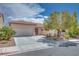 Charming single-story home with a well-manicured front yard and a two-car garage at 7908 Morning Gallop Ct, Las Vegas, NV 89131