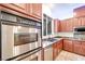 Kitchen featuring stainless double oven and undermount sink under a window at 7908 Morning Gallop Ct, Las Vegas, NV 89131