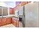 Stainless steel refrigerator and gas stove top, granite countertops and wood cabinets at 7908 Morning Gallop Ct, Las Vegas, NV 89131