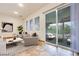 Stylish living room features tile flooring, sliding doors to backyard, and large windows at 7908 Morning Gallop Ct, Las Vegas, NV 89131