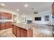 Large living space with open concept kitchen and island plus fireplace and flat screen television at 7908 Morning Gallop Ct, Las Vegas, NV 89131