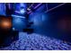 Theater room features themed carpet, custom lighting, shelves, and projector at 7908 Morning Gallop Ct, Las Vegas, NV 89131