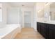 Bathroom offers a walk-in shower, bathtub, and a double sink vanity at 8224 Cassis Ct, Las Vegas, NV 89117