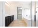 Bathroom featuring tub, walk-in closet, and vanity with dark cabinets at 8224 Cassis Ct, Las Vegas, NV 89117